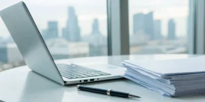 Modern office desk with a laptop for planning strategic staffing solutions.